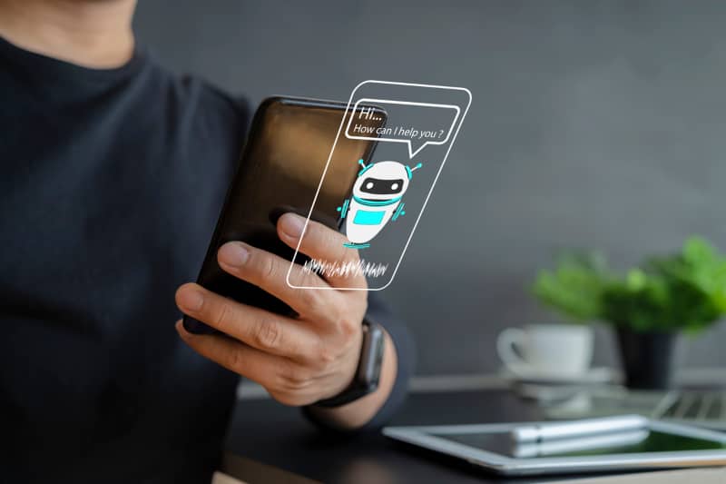 hombre sosteniendo un dispositivo para hablar con un chatbot